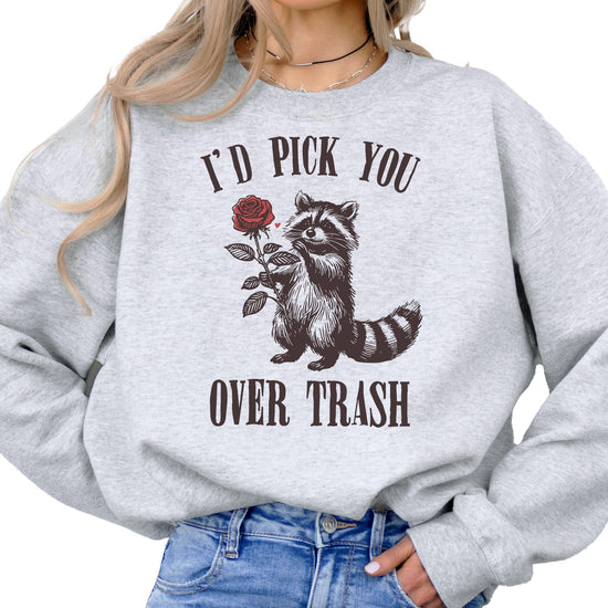Close-up of raccoon Valentine's Day graphic print on white sweatshirt showing print detail and quality