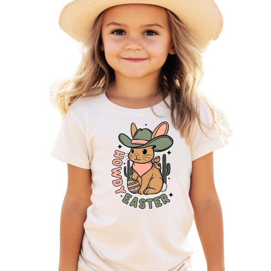 Close-up of Howdy Easter desert bunny graphic print on girls' peach youth tee