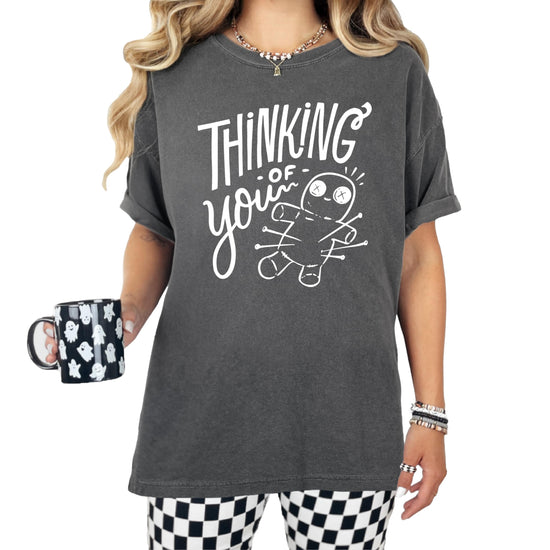 Woman wearing black Thinking of You voodoo doll Halloween shirt casual styling