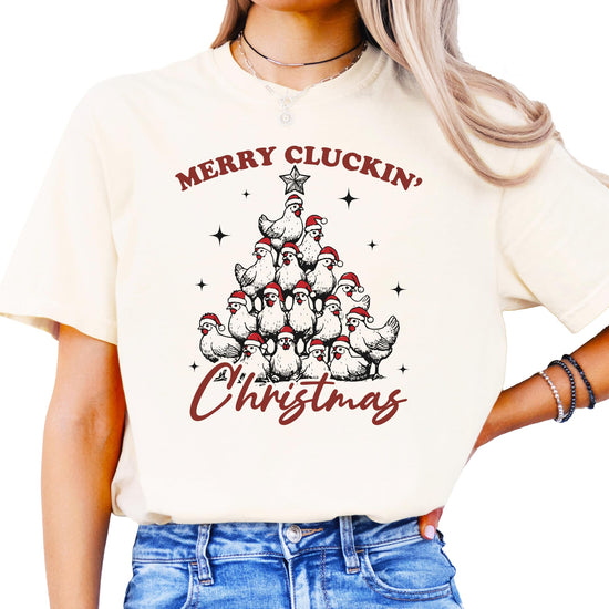 Close-up of Merry Cluckin' Christmas chicken holiday graphic on seafoam shirt