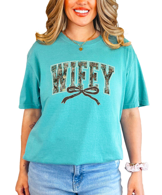 Close-up view of wifey text in camouflage varsity lettering with pink bow accent