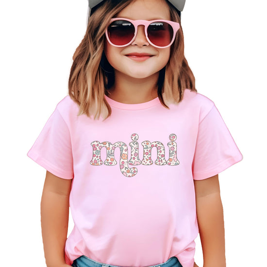 Close-up of retro floral font graphic print on pink mama and mini matching tee