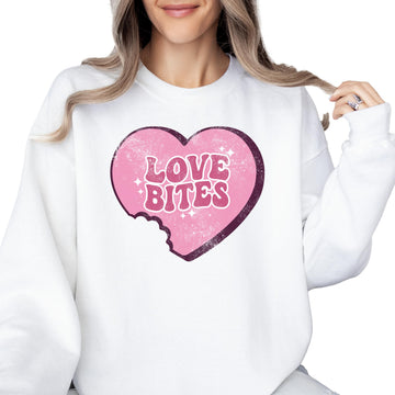 Woman wearing a cozy crewneck sweatshirt with a Love Bites heart graphic for Valentine's Day