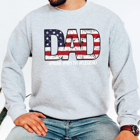 Close-up of Dad Man Myth Legend sweatshirt print showing weathered American flag letter detail