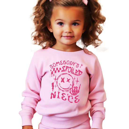 Somebody's Spoiled Niece pink crewneck sweatshirt with grunge-style graphic for kids and toddlers
