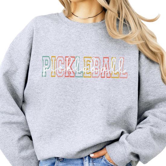 Model wearing retro pickleball graphic sweatshirt, casual lifestyle styling