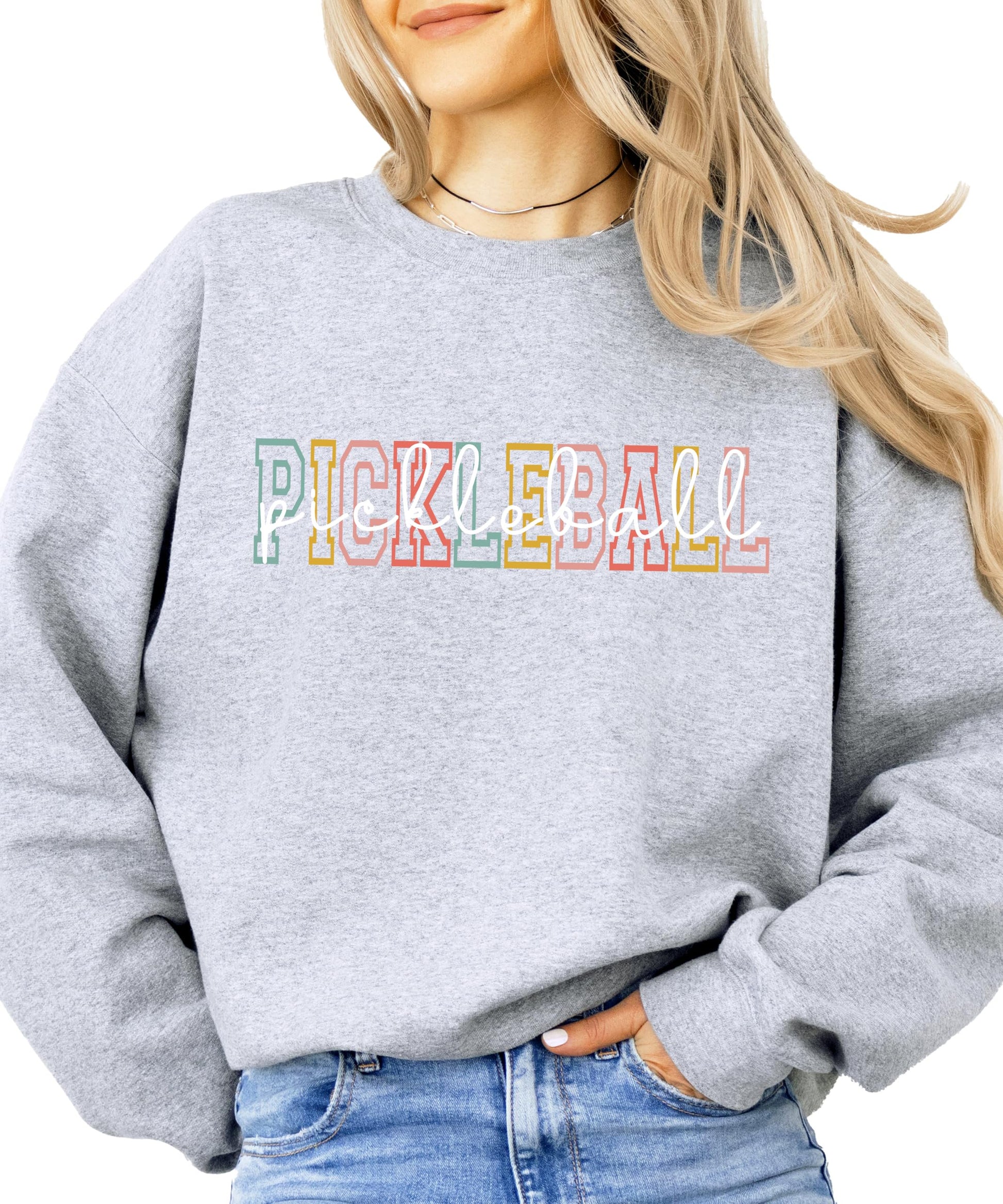 Model wearing retro pickleball graphic sweatshirt, casual lifestyle styling