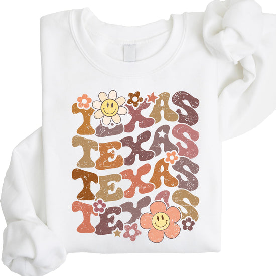 Detail shot of colorful smiley face flowers on Texas sports sweatshirt