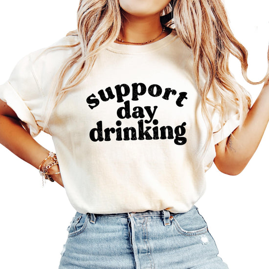 Support Day Drinking text design close-up on women's t-shirt