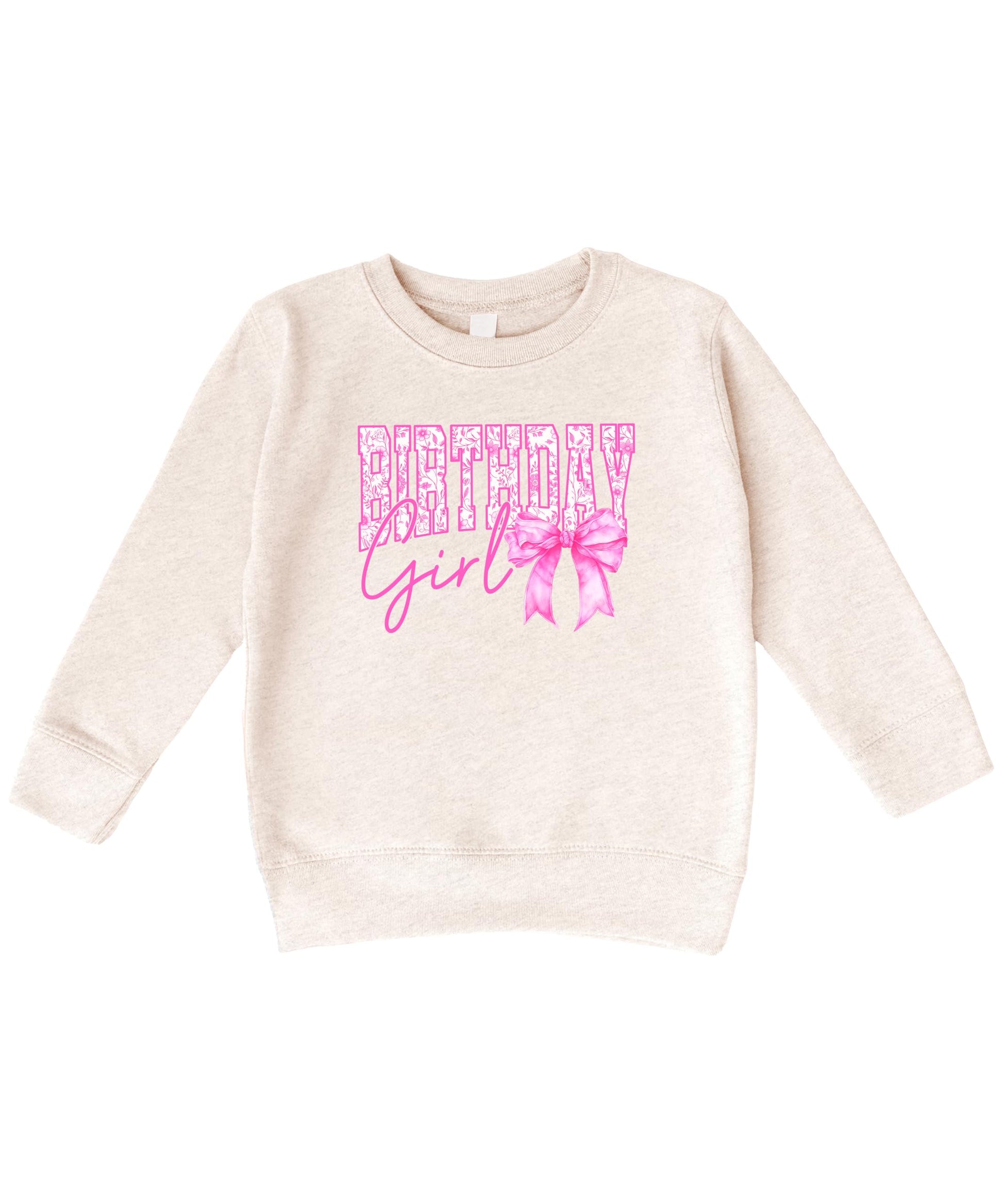 Close-up of Birthday Girl bow sweatshirt showing sparkly pink lettering and bow graphic detail