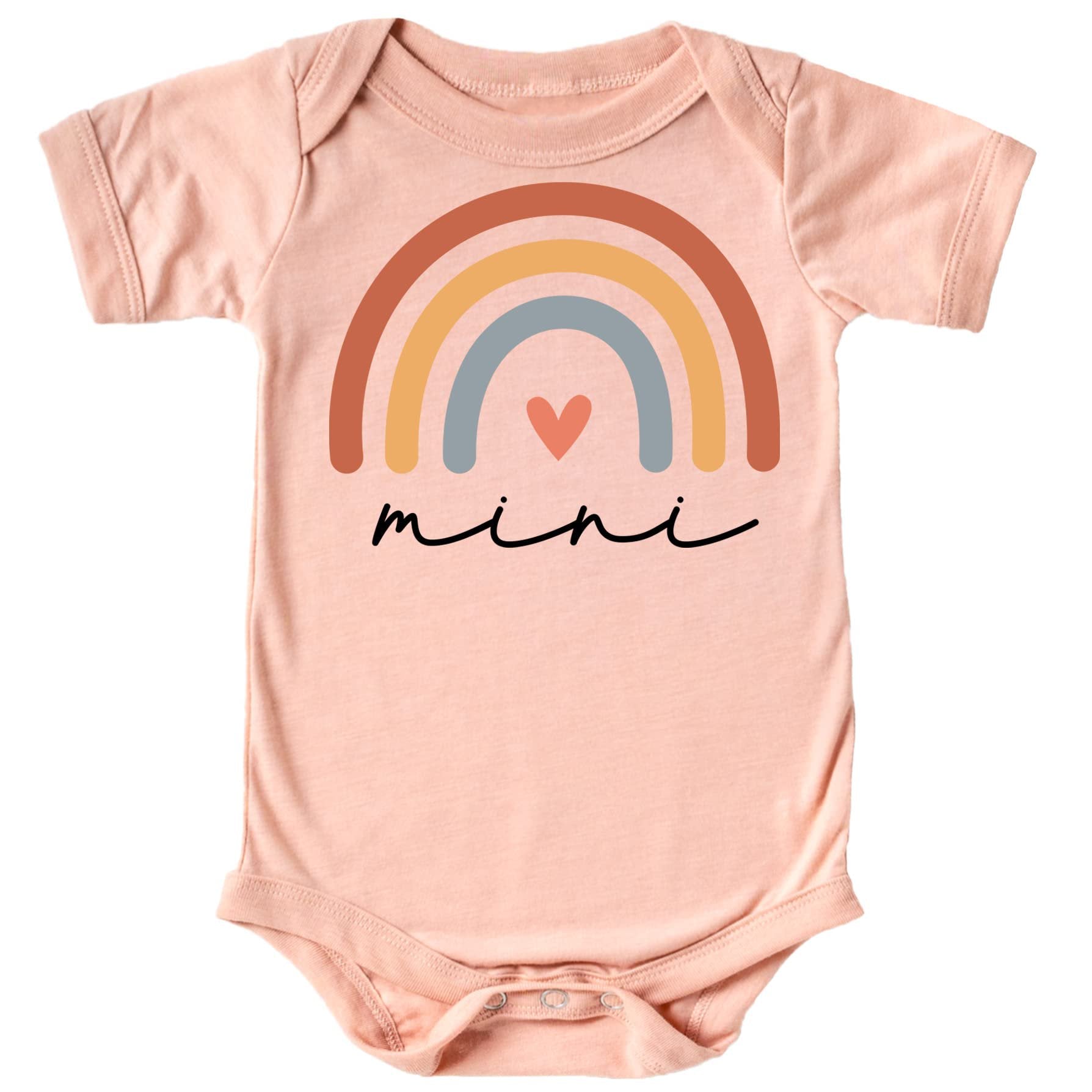 Close-up of vibrant rainbow heart cursive graphic print on peach mommy and me matching shirt