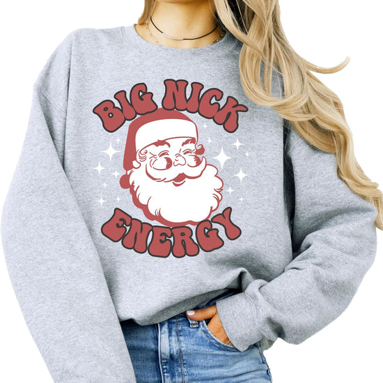 Front view of funny Big Nick Energy Christmas sweatshirt with bold retro Santa design