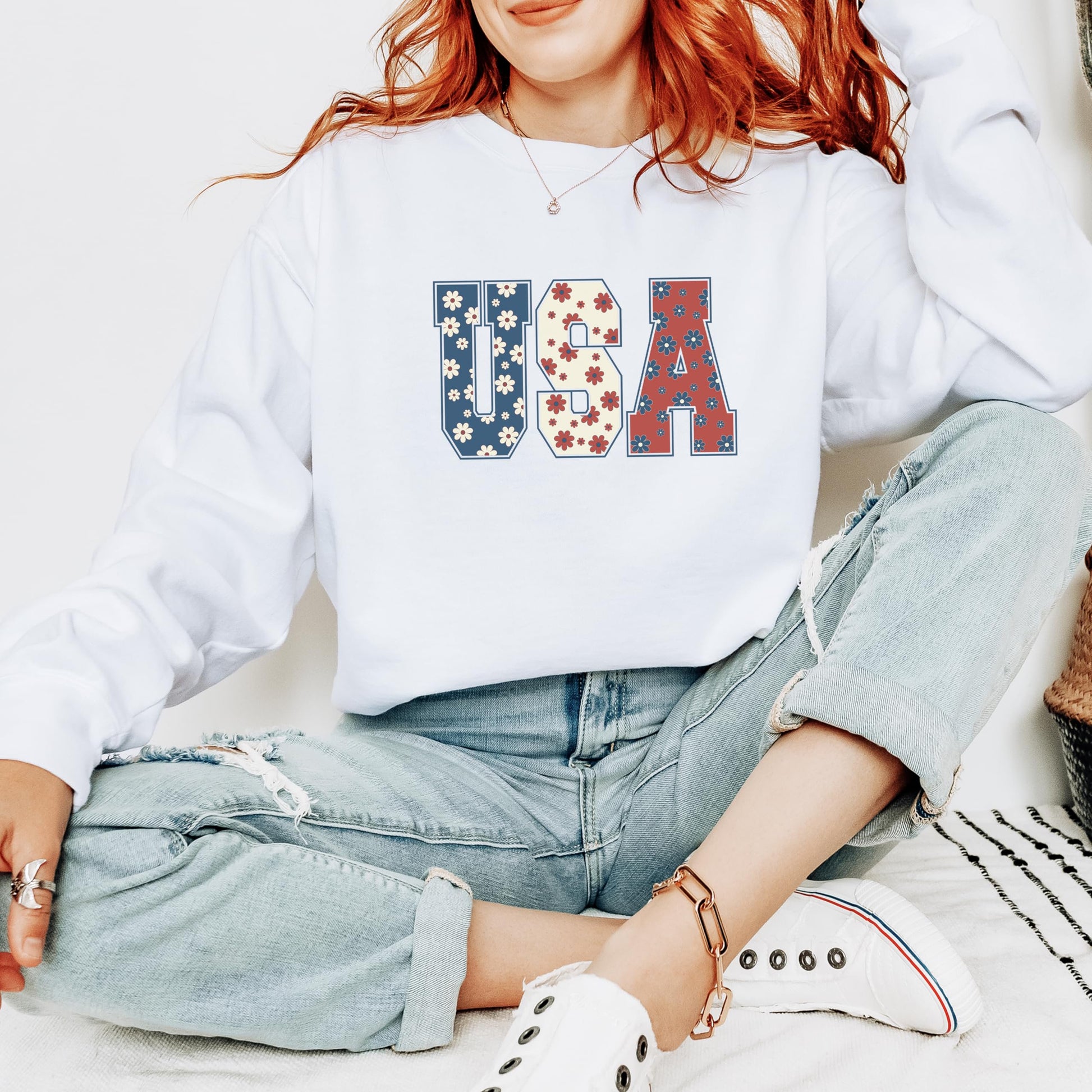 Teen girl wearing white patriotic floral USA sweatshirt perfect for 4th of July