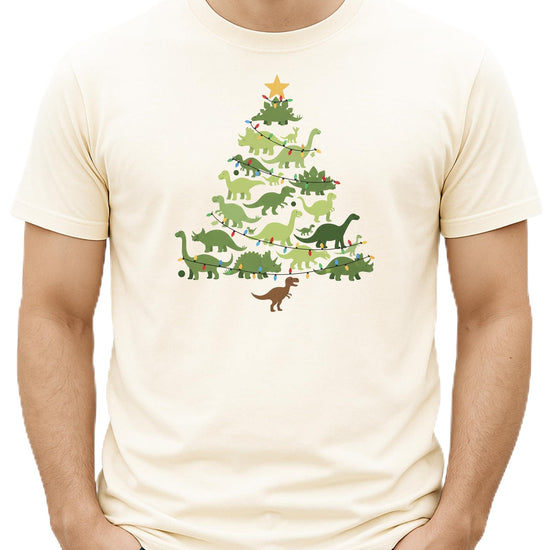 Green dinosaur Christmas tree shirt on natural colored tee - front view of holiday graphic design