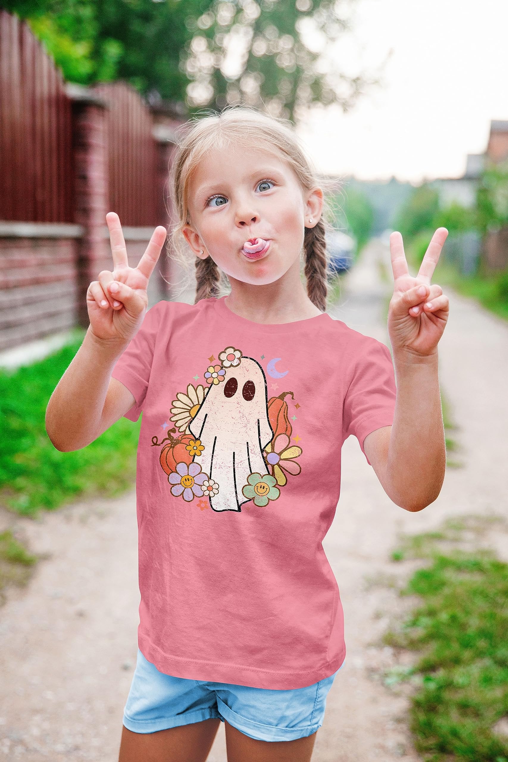 Purple Halloween shirt for toddler girls with groovy ghost design, laid flat
