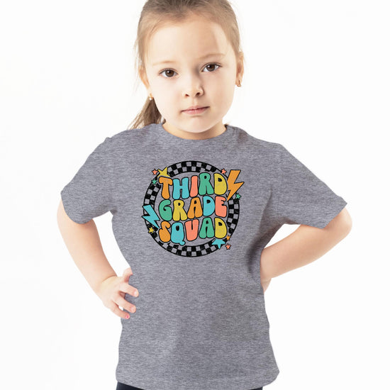 3rd Grade Squad lightning bolt graphic tee laid flat showing full design detail on natural fabric