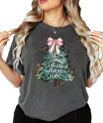 Seafoam women's tee with illustrated Christmas tree, pink bow topper, and Oh Come Let Us Adore Him graphic