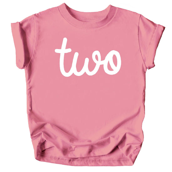 Toddler girl wearing a purple short-sleeve birthday shirt with cursive 'Two' graphic for 2nd birthday