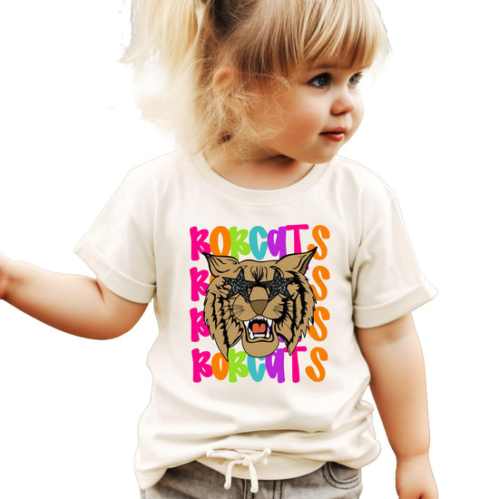 Front view of Bobcats spirit tee featuring vibrant wavy text and bold bobcat mascot graphic