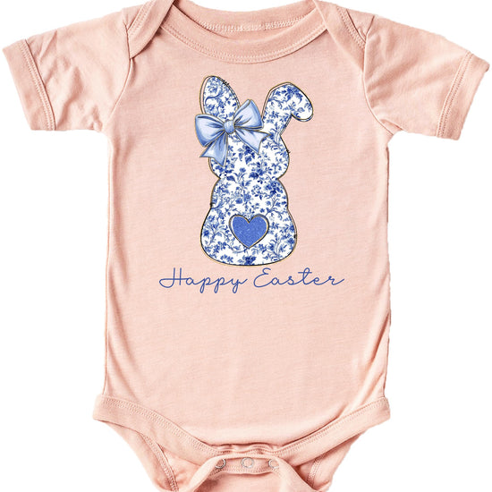 Baby girl wearing a peach Happy Easter bodysuit with blue chinoiserie floral bunny and bow design