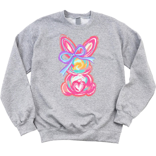 Close-up of painted Easter bunny design on girls white sweatshirt showing vibrant colorful print detail