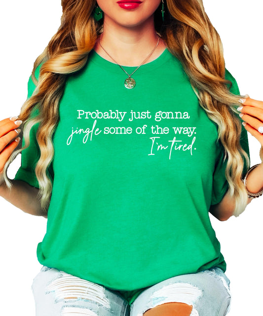 Close-up of holiday humor graphic tee with jingle quote on vintage green fabric
