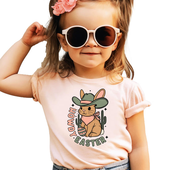 Detail shot of Howdy Easter graphic tee print quality on soft peach girls' youth shirt