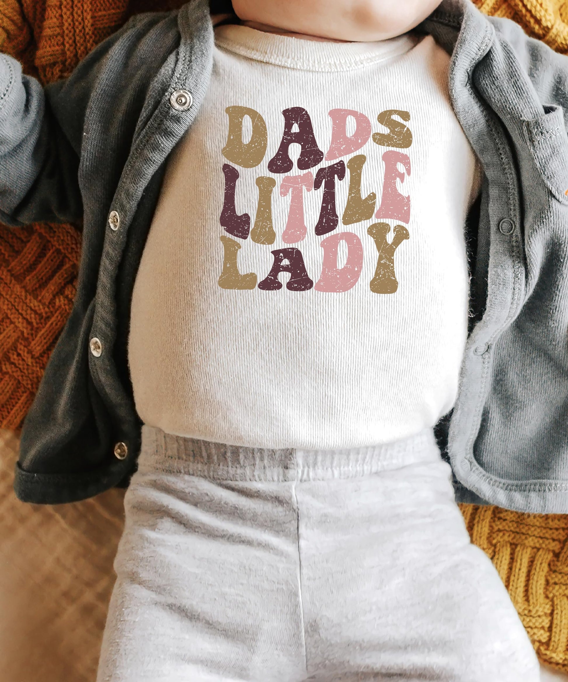 Baby girl wearing Dad's Little Lady snap bodysuit with retro graphic print
