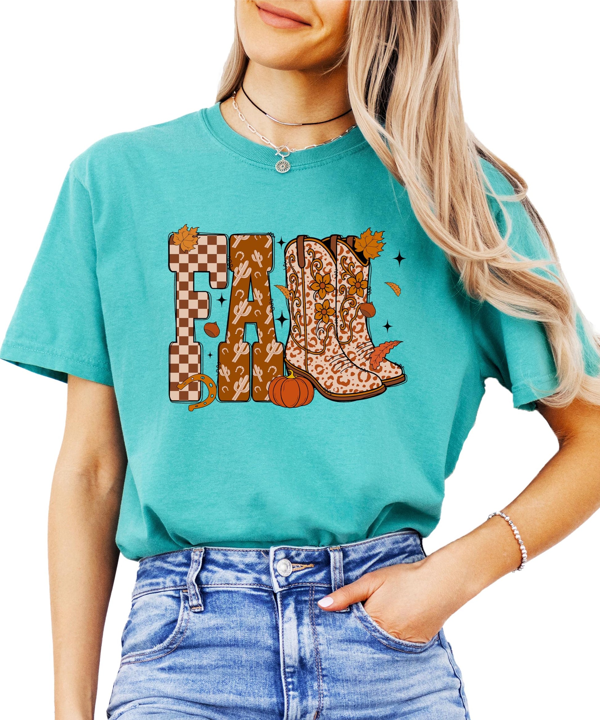 Close-up of fall cowboy boots graphic on seafoam women's tee showing pumpkins and leaf details