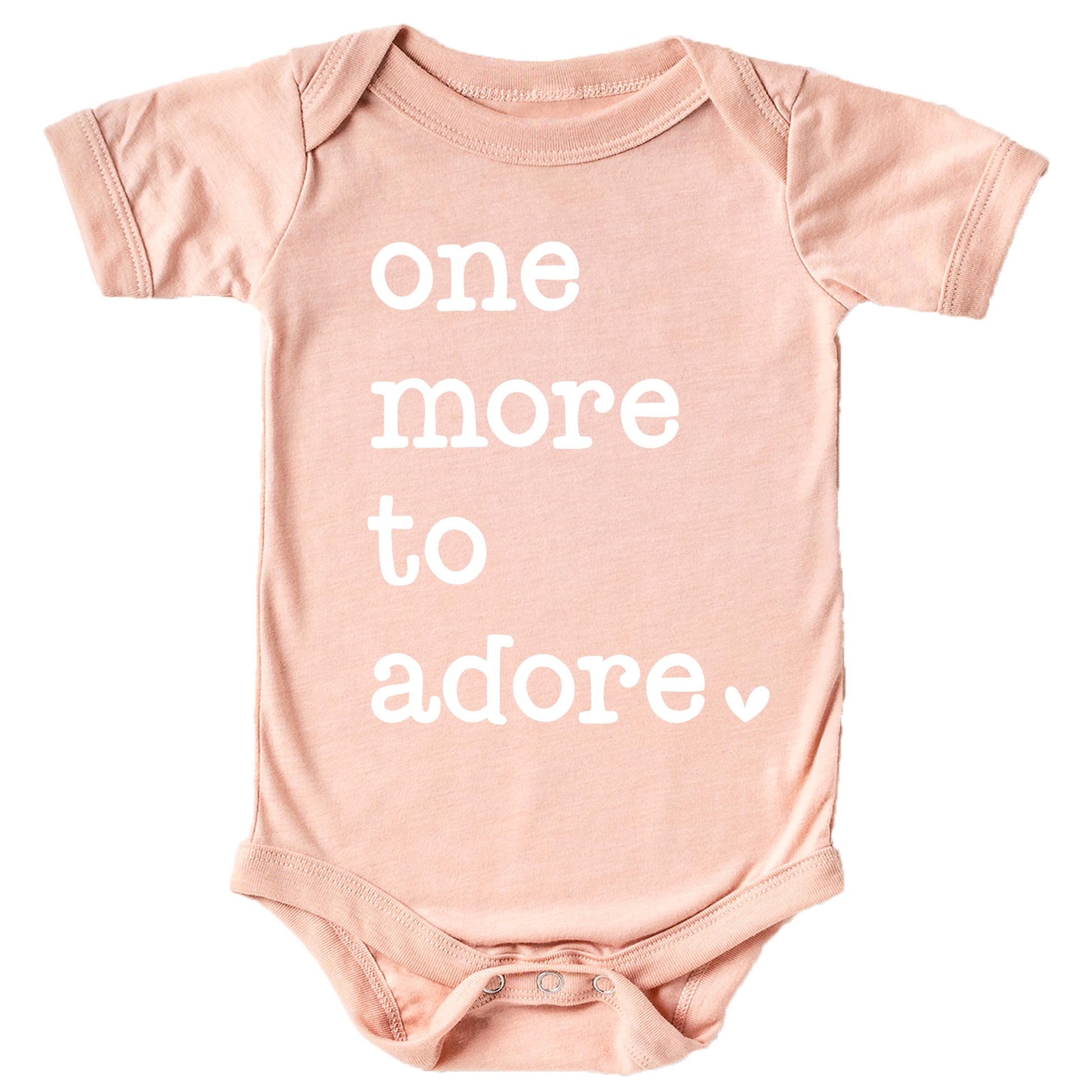 White graphic 'One More to Adore' baby bodysuit on military green fabric, newborn pregnancy reveal outfit