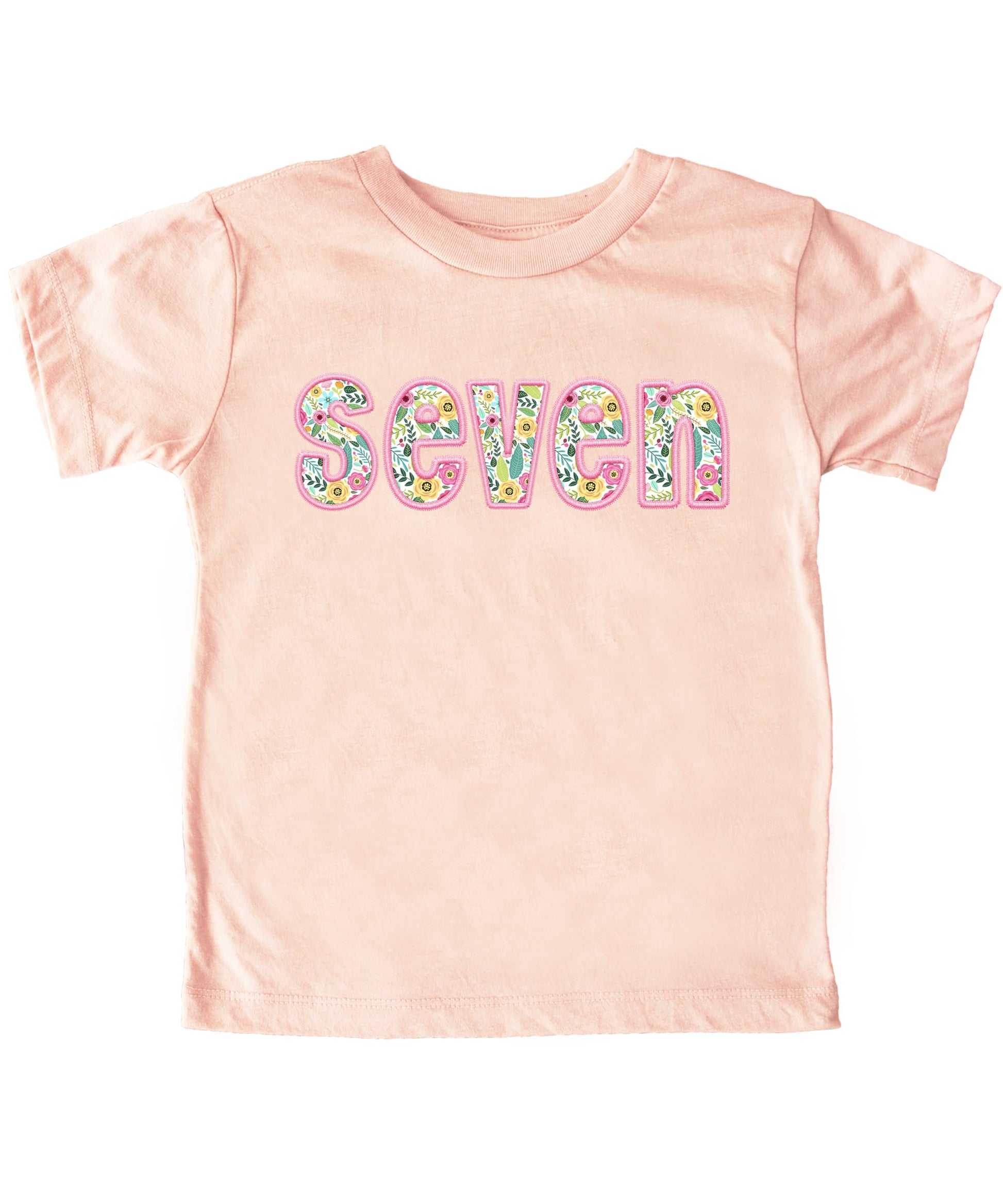 Girls 7th birthday shirt flat lay showing full design and peach color