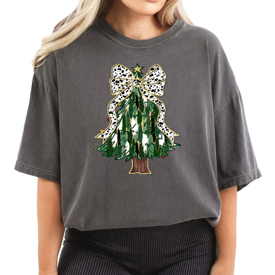 Women's ivory graphic tee featuring a painted Christmas tree with a dalmatian dots coquette bow and gold star topper