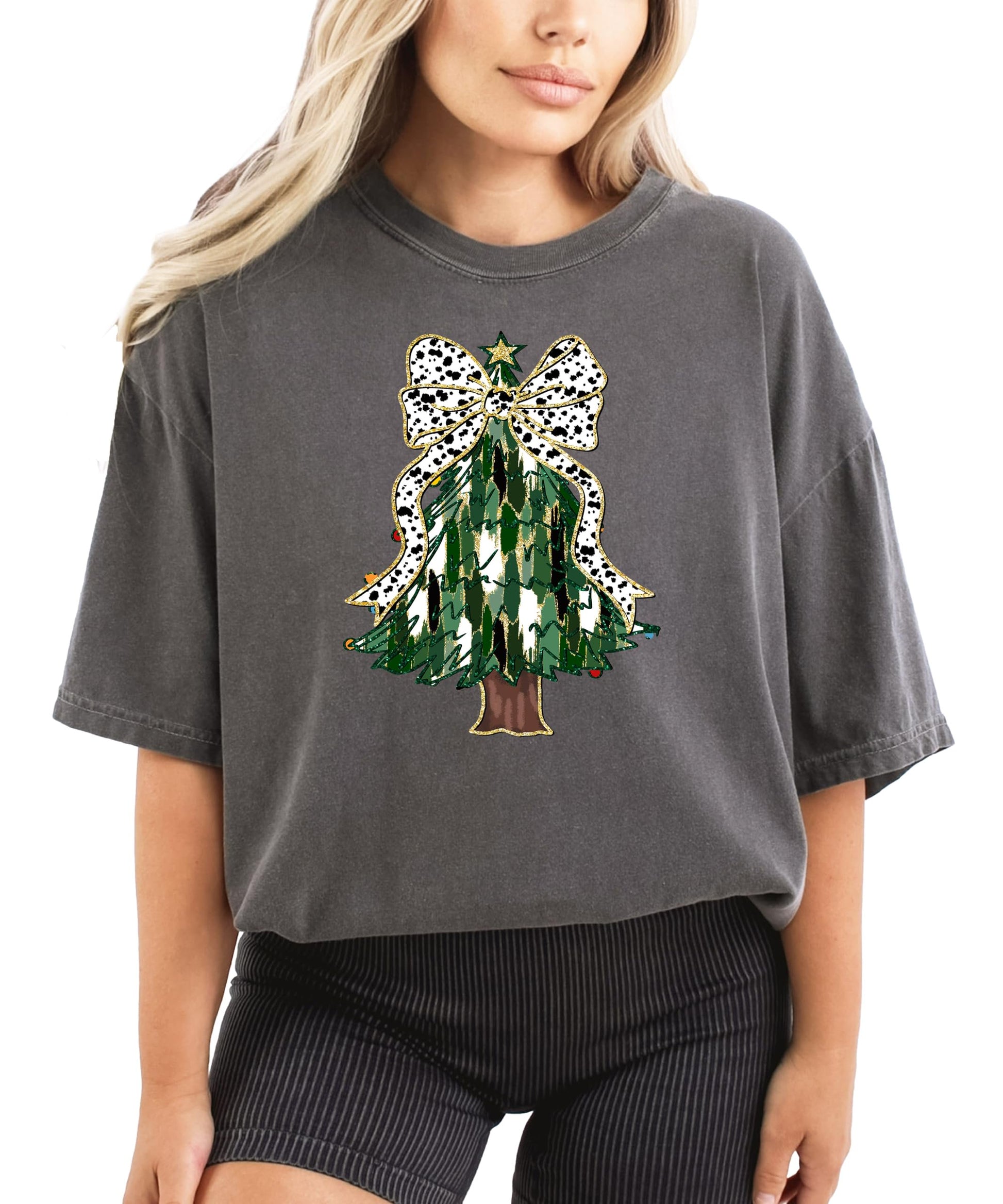 Women's ivory graphic tee featuring a painted Christmas tree with a dalmatian dots coquette bow and gold star topper