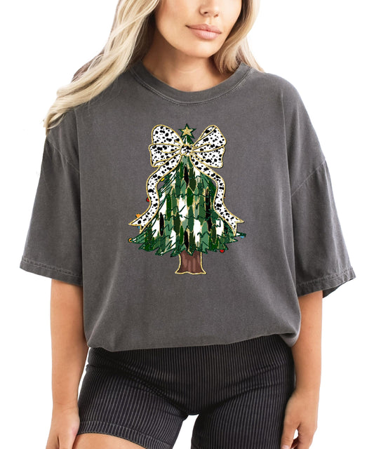 Women's ivory graphic tee featuring a painted Christmas tree with a dalmatian dots coquette bow and gold star topper