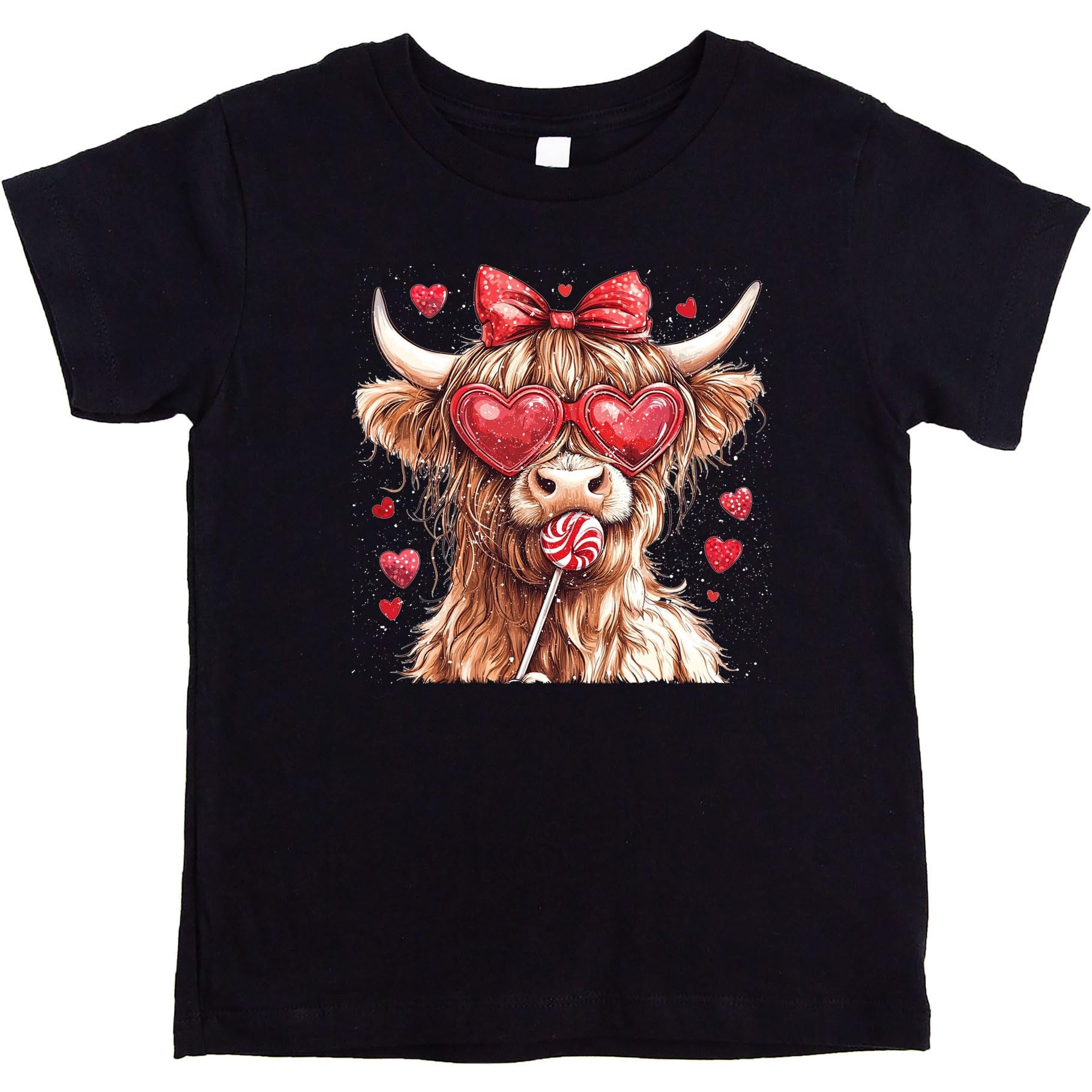 Close-up of Highland cow graphic with hearts and candy on pink kids' shirt