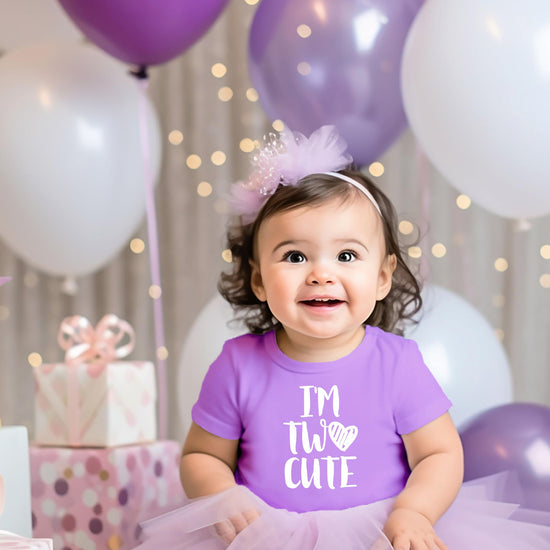 Flat lay of mauve toddler birthday shirt with I'm Two Cute white print design