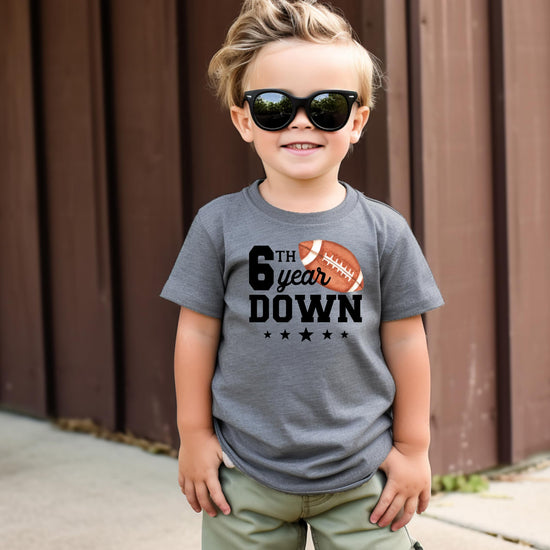 6 year old birthday football tee laid flat showing full graphic print detail