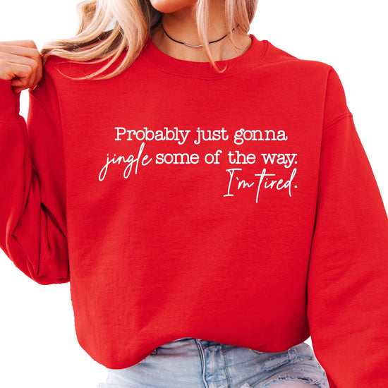 Flat lay of red women's Christmas crewneck sweatshirt with humorous holiday saying