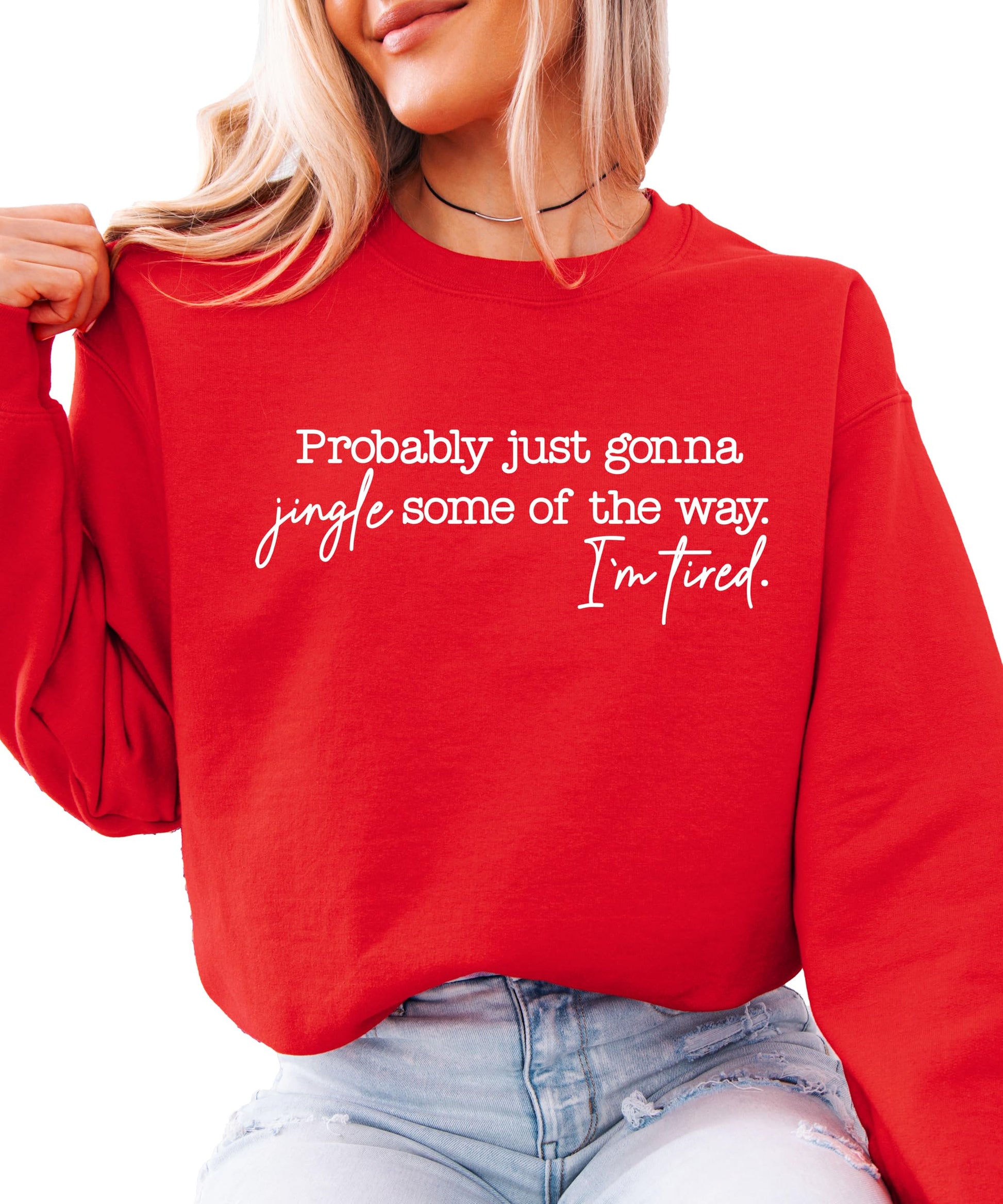 Flat lay of red women's Christmas crewneck sweatshirt with humorous holiday saying