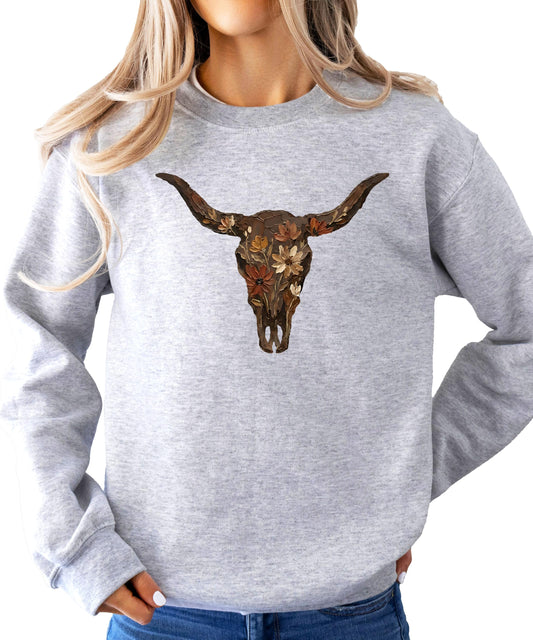 Front view of Olive Loves Apple western cowgirl pullover sweatshirt with bold longhorn skull graphic