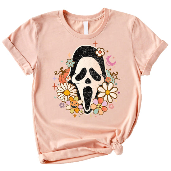 Close-up of groovy Scream horror mask graphic print on women's Halloween tee