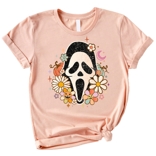 Close-up of groovy Scream horror mask graphic print on women's Halloween tee