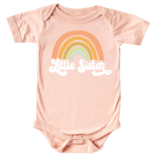 Retro rainbow Little Sister sibling reveal bodysuit in white on mauve for baby girls by Olive Loves Apple