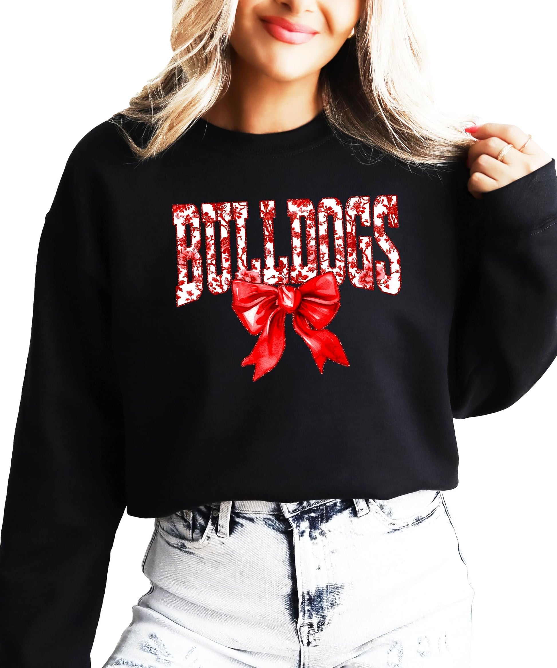 Woman wearing black Bulldogs spirit sweatshirt with red bow