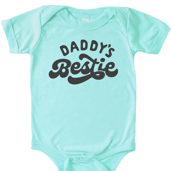 Lifestyle or styled shot of Daddy's Bestie retro graphic baby bodysuit, perfect baby shower gift