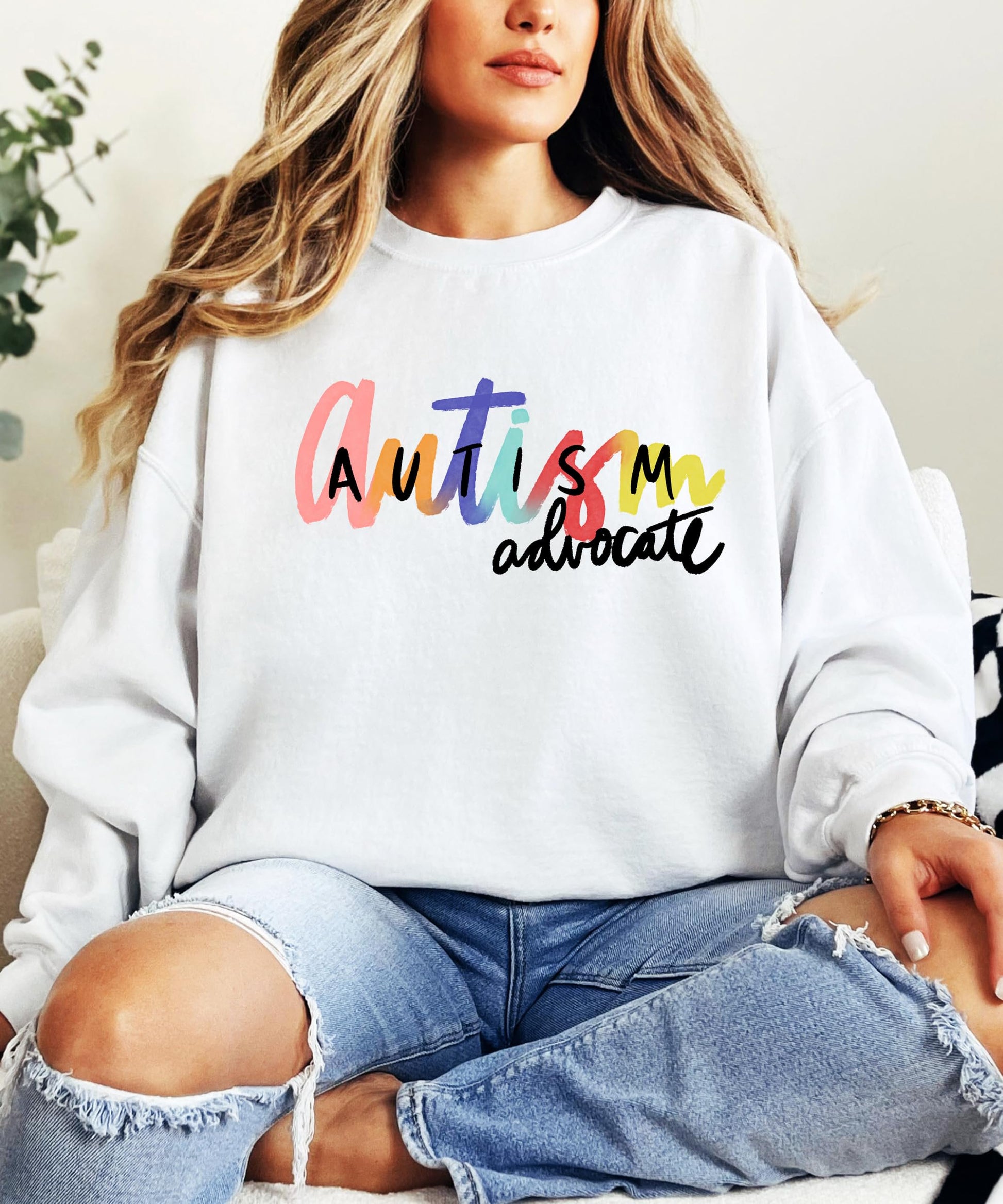 Olive Loves Apple Autism Advocate women's sweatshirt laid flat showing full colorful design