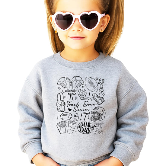Close-up view of Touch Down Season football graphic design on gray sweatshirt showing game day elements