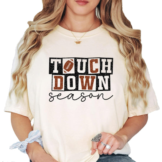 Woman wearing oversized ivory Touchdown Season football tee with checkered graphics