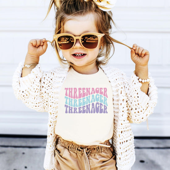 Close-up of Threenager groovy third birthday graphic tee print for toddler girls