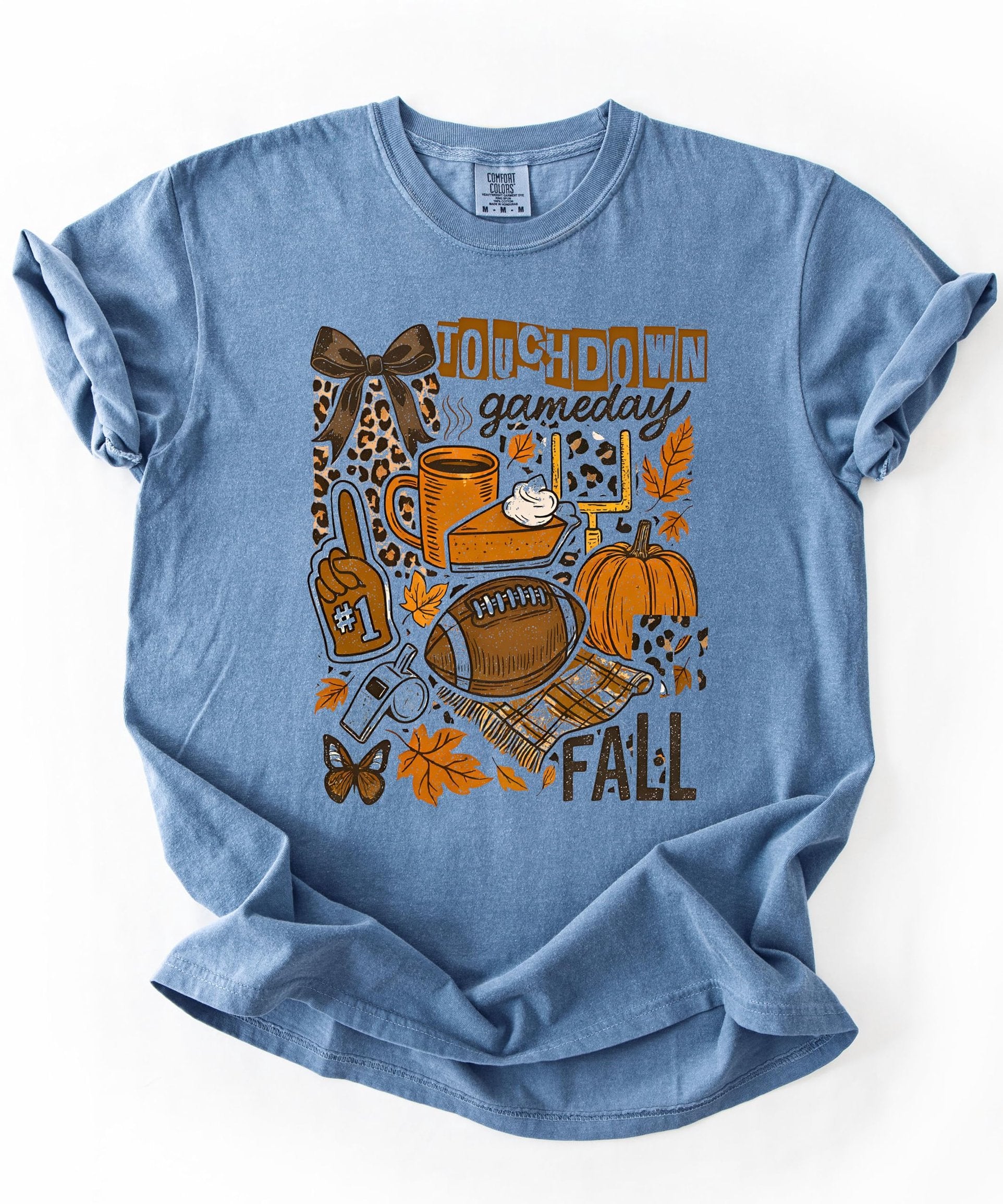 Fall football graphic tee styled on model showing relaxed fit and autumn-themed design